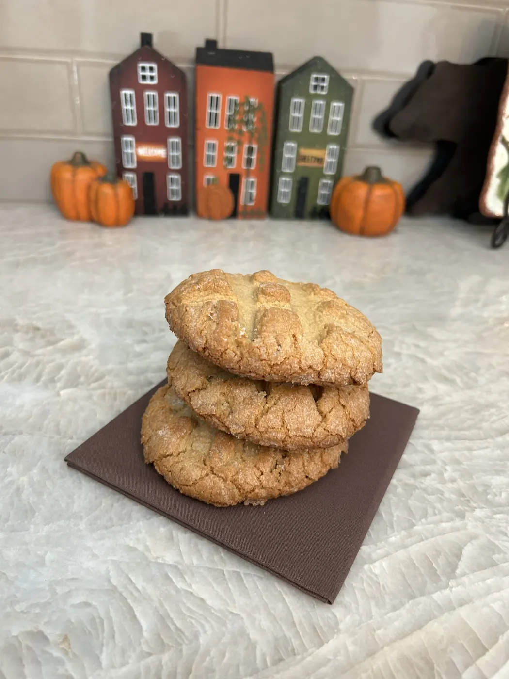 A stack of three peanut butter cookies