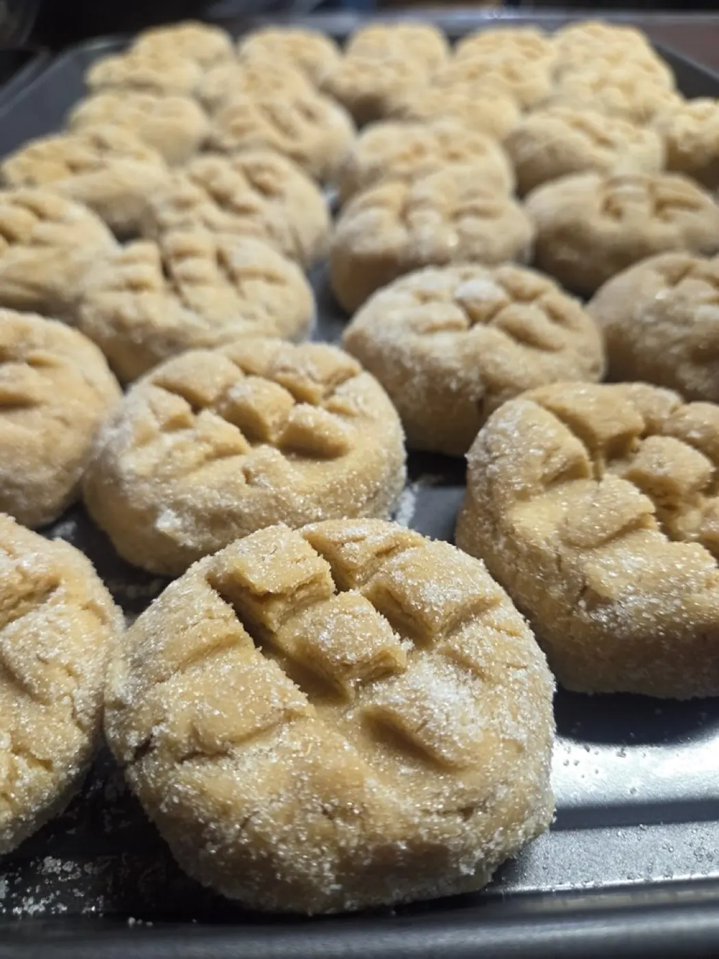 A tray of hand-rolled peanut butter cookies ready for the oven